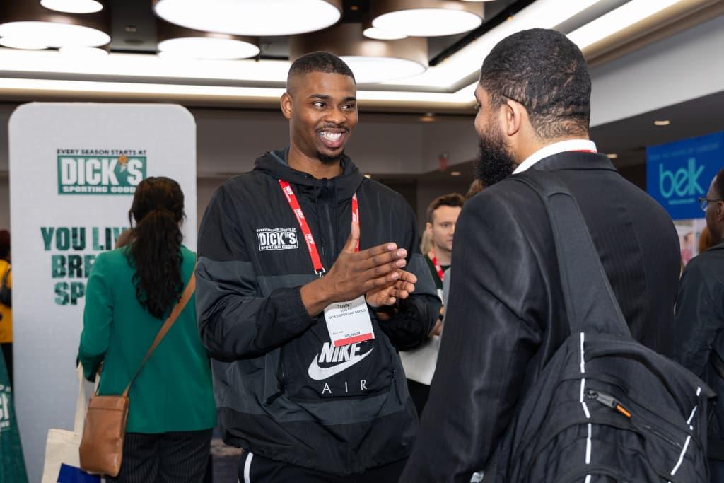 A recruiter from DICK'S Sporting Goods chats with an attendee to the NRF Foundation Student Program Career Fair