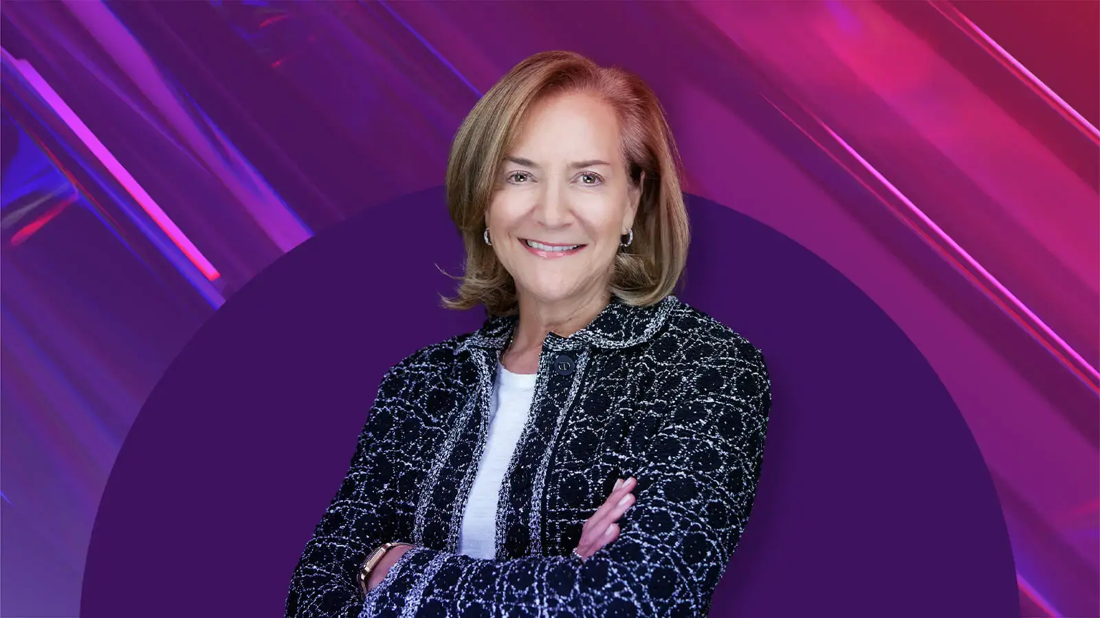 Fran Horowitz is the Visionary 2026. She poses with her arms crossed in front of shades of purple, blue and red.